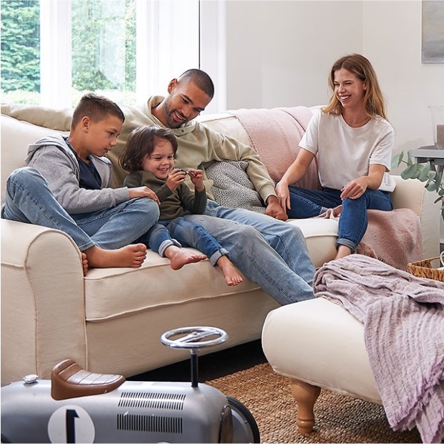 Family gathered on cream sofa